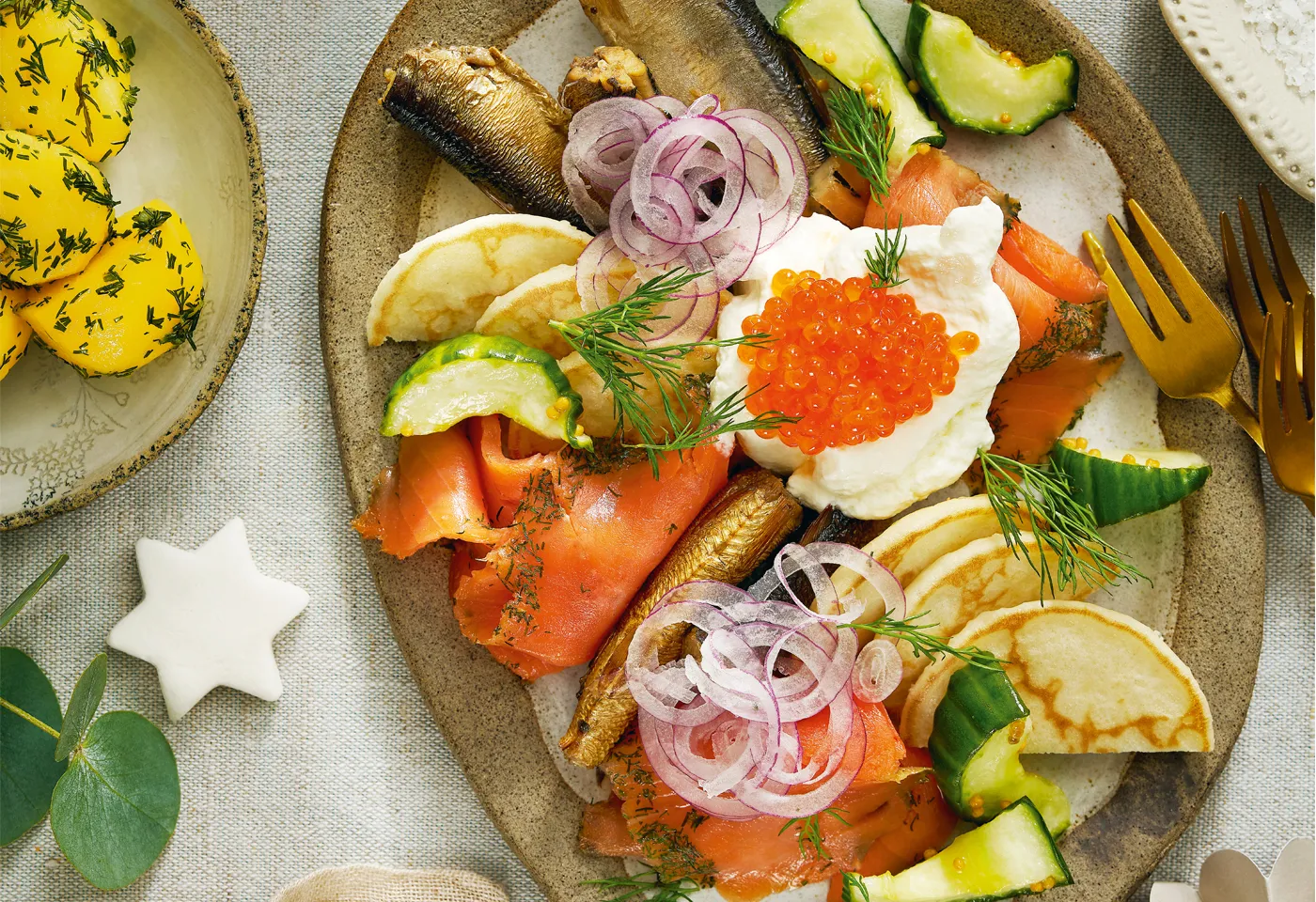 Nordischer Fischteller mit eingelegten Gurken und Dillerdäpfeln