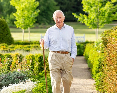 King Charles walking on a path