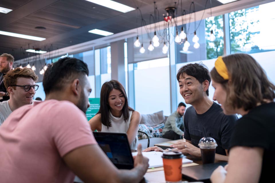 5 people sitting around talking
