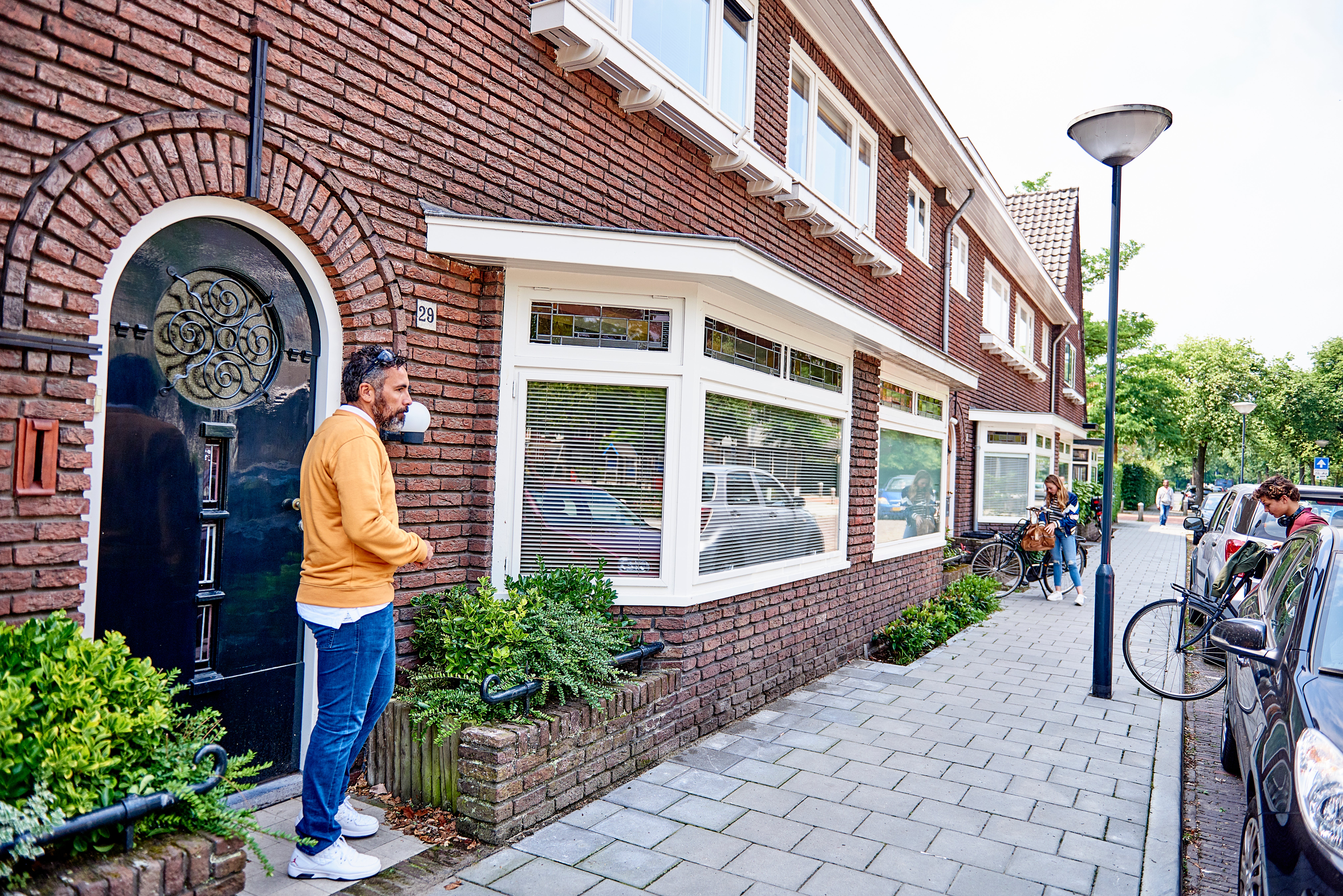 man staat bij voordeur