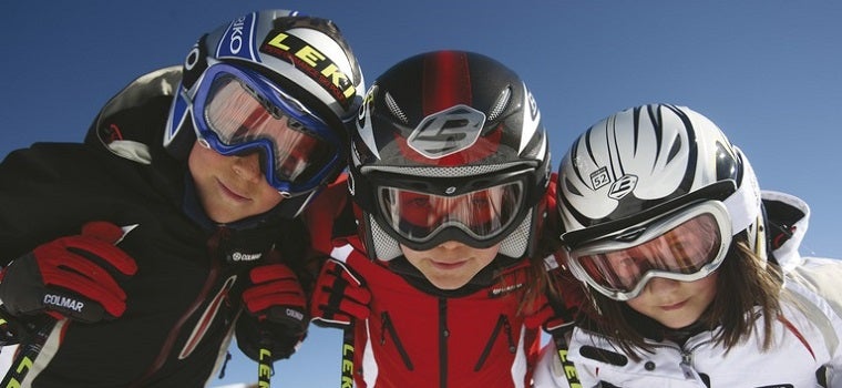 Nahaufnahme von drei Kindern mit Skihelm und Skibrillen