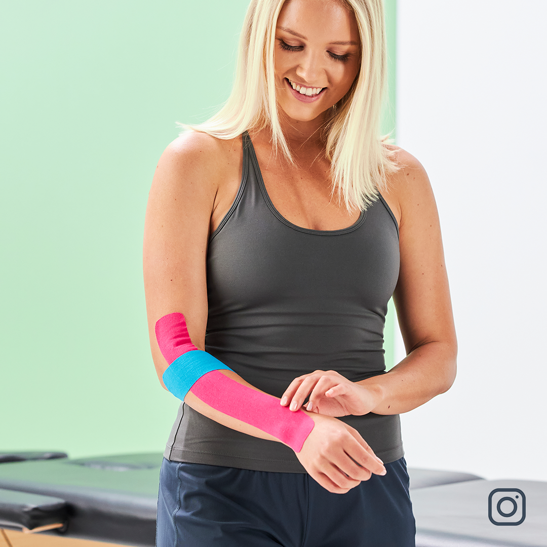 Frau verwendet das Kinesiotape am Ellenbogen