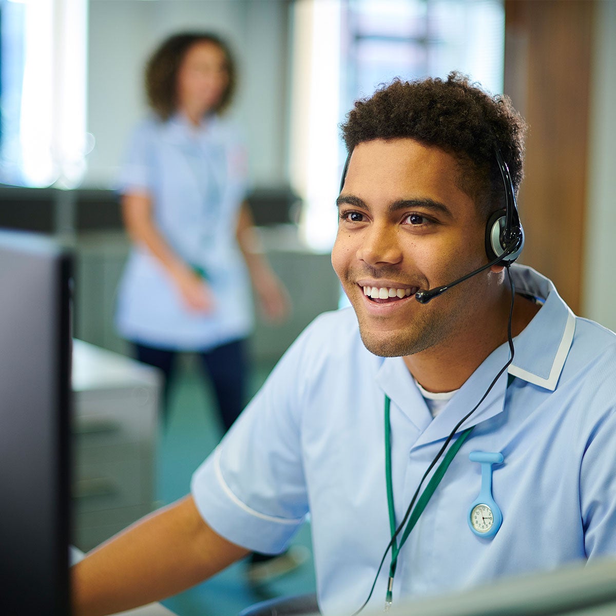 Man with a headset piece providing online support to queries