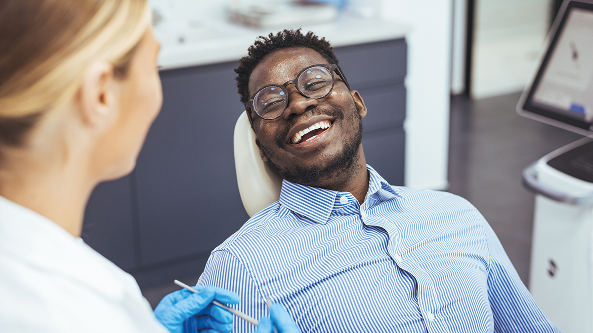 Smiling man in dentists chair
