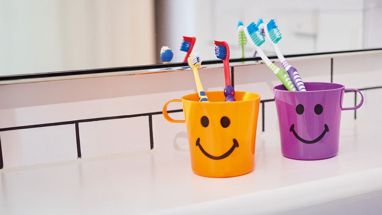 A group of toothbrushes in a cup