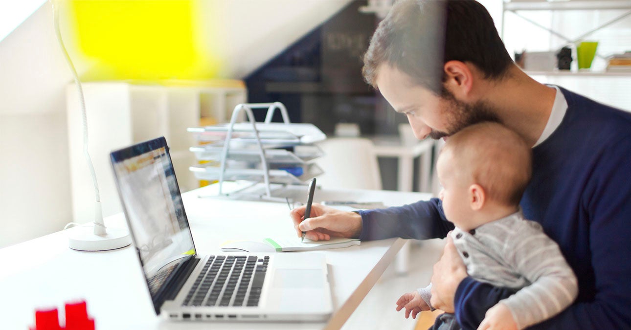 Dad working from home with child