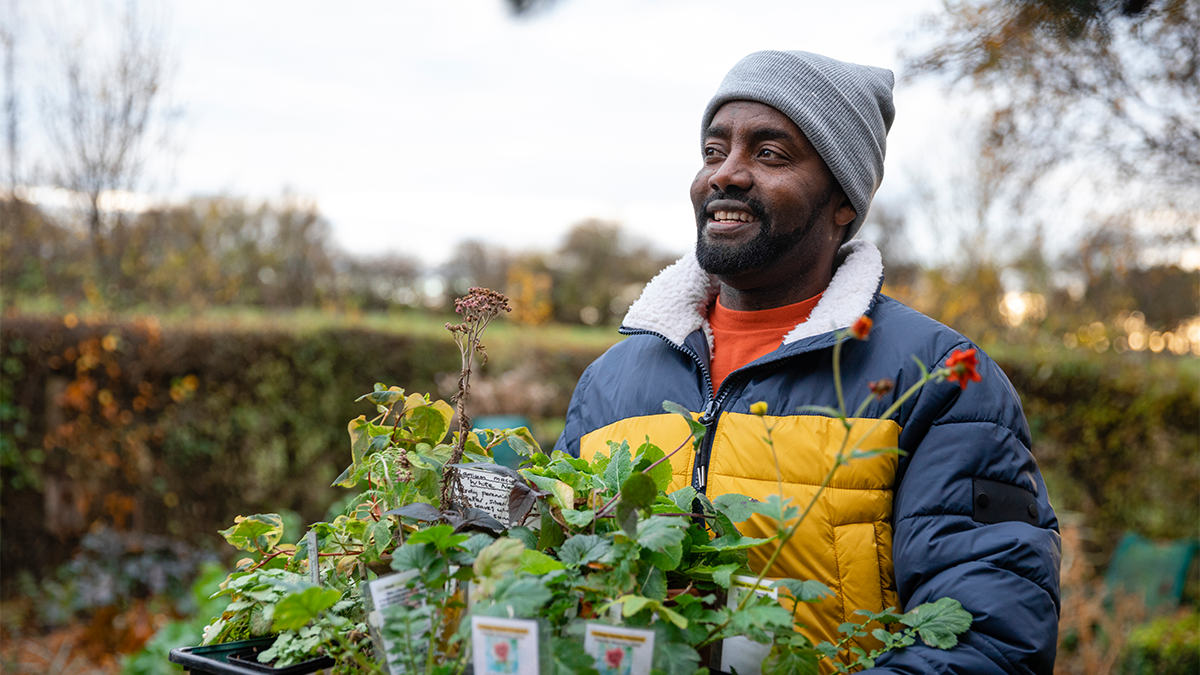 A man holding a potted plant