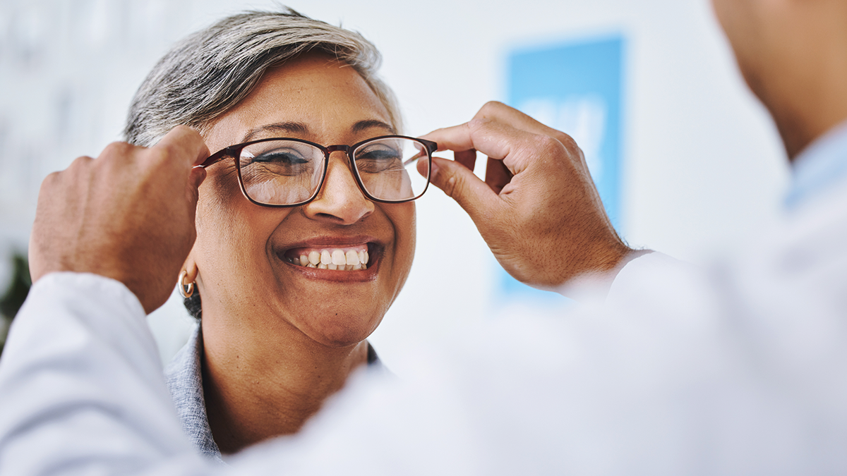 Woman smiling trying on glasses