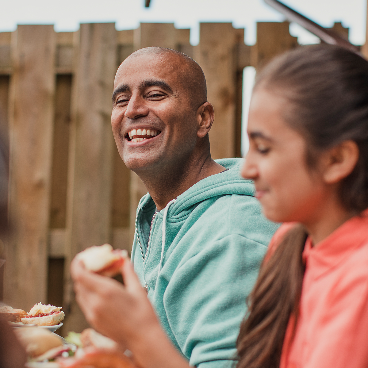 Smiling man enjoying outdoor lunch