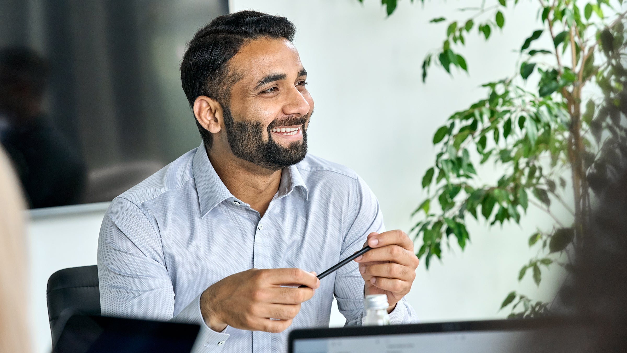 Employee having a discussion, smiling in the office environment