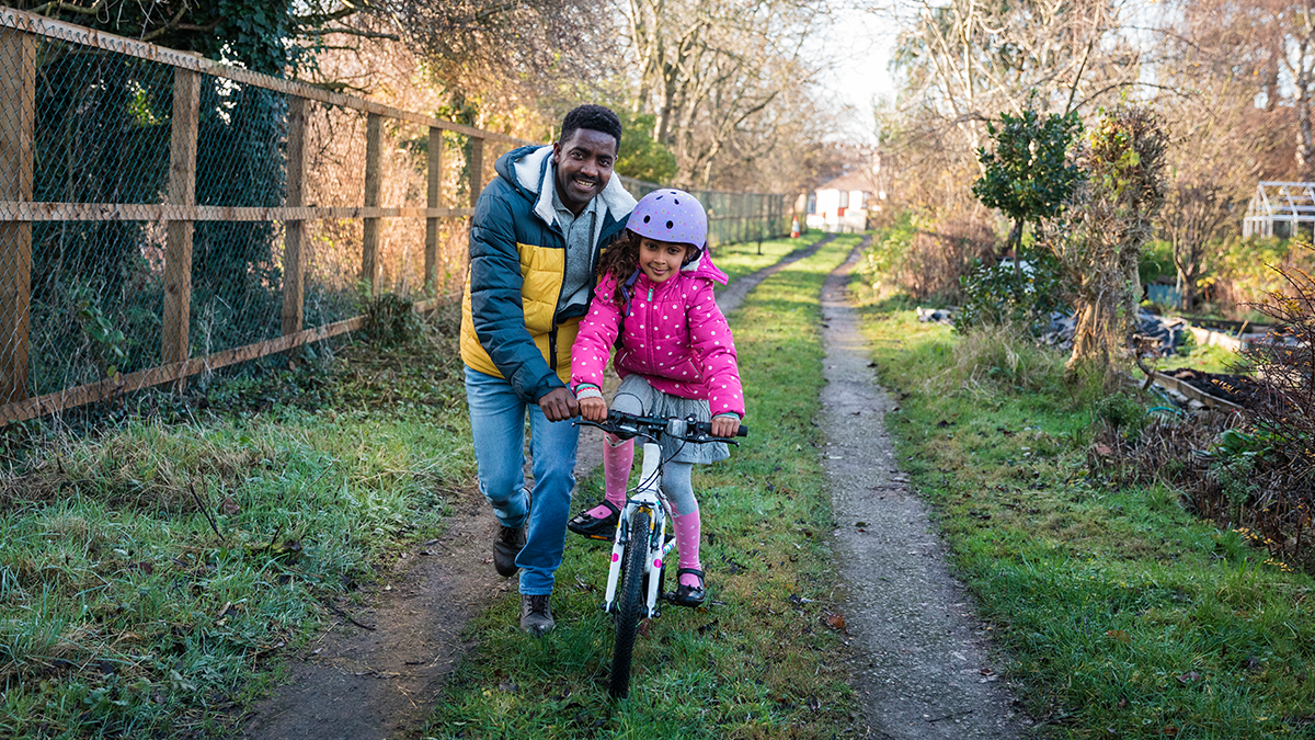 A man and girl riding a bike