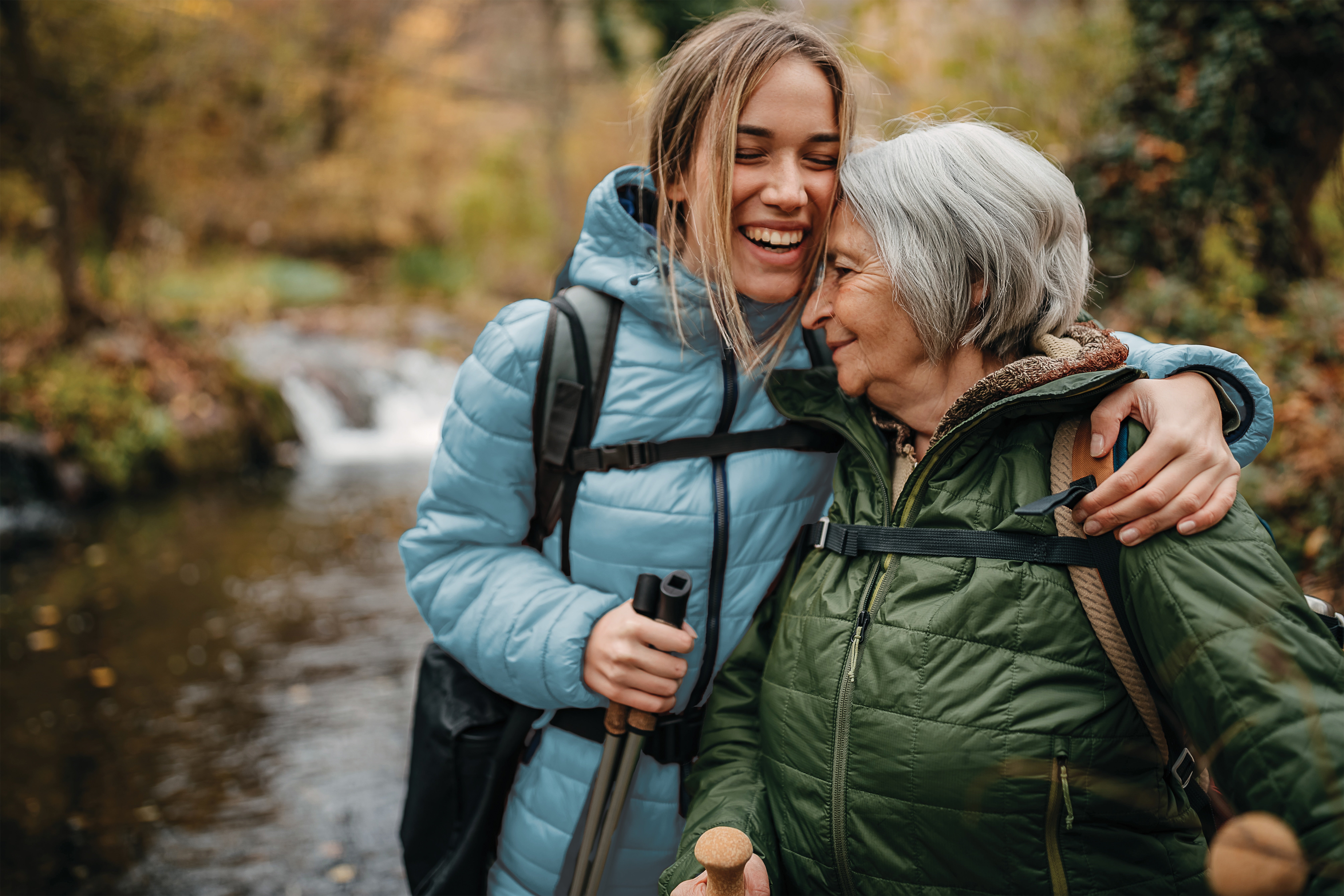 Two women standing next to each other hugging