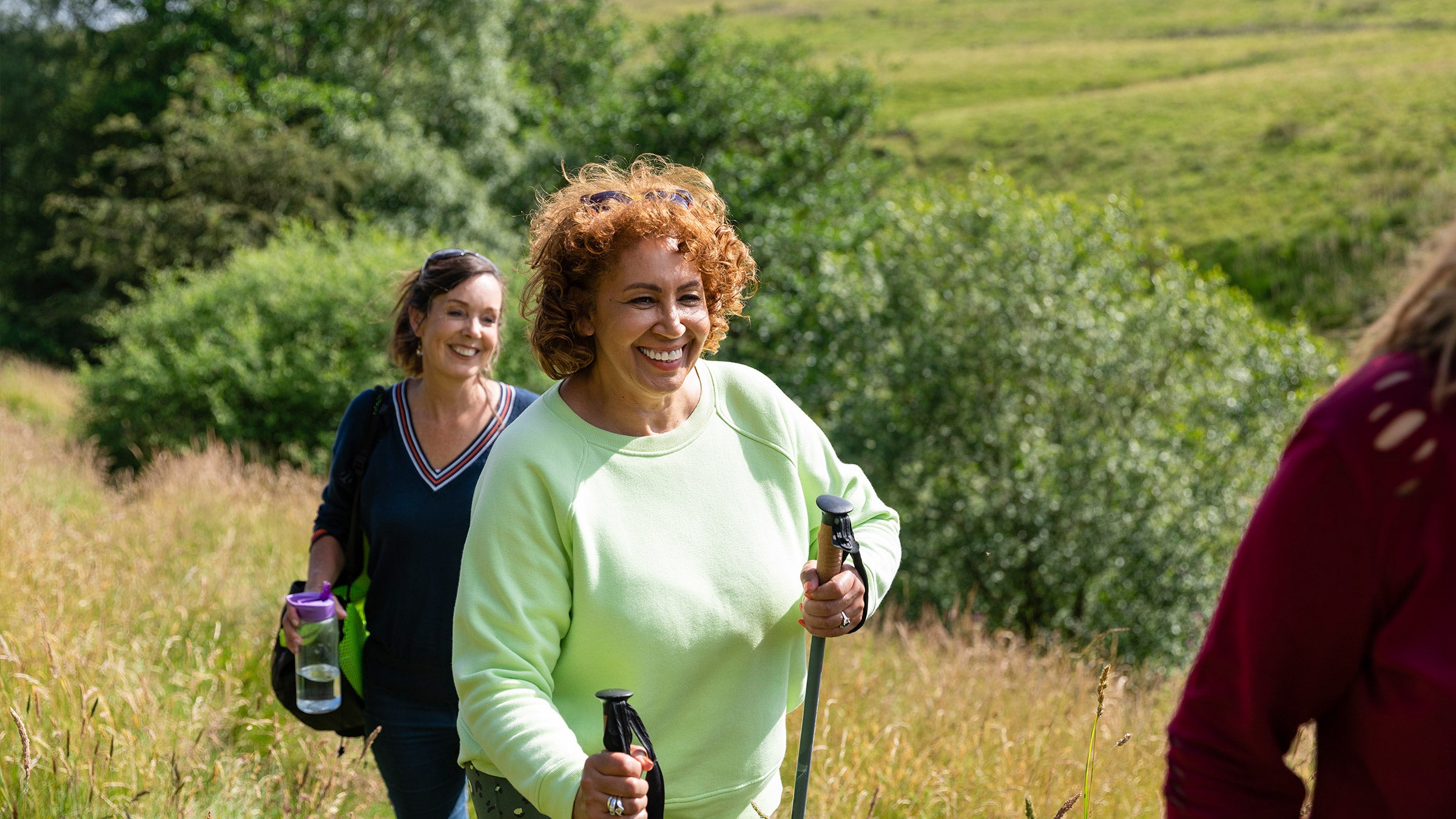 Women climbing the hill together