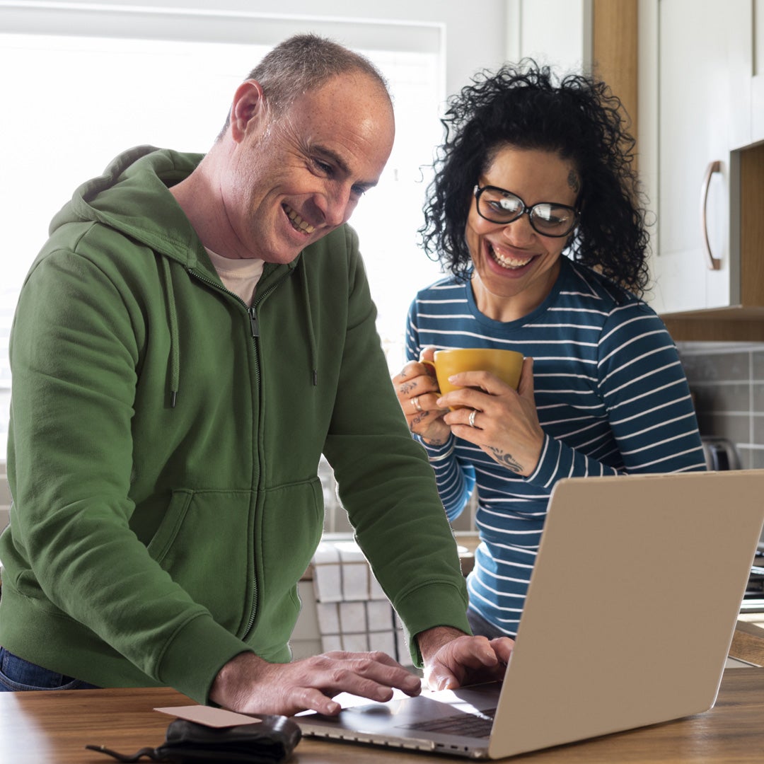 A man and woman looking at a laptop