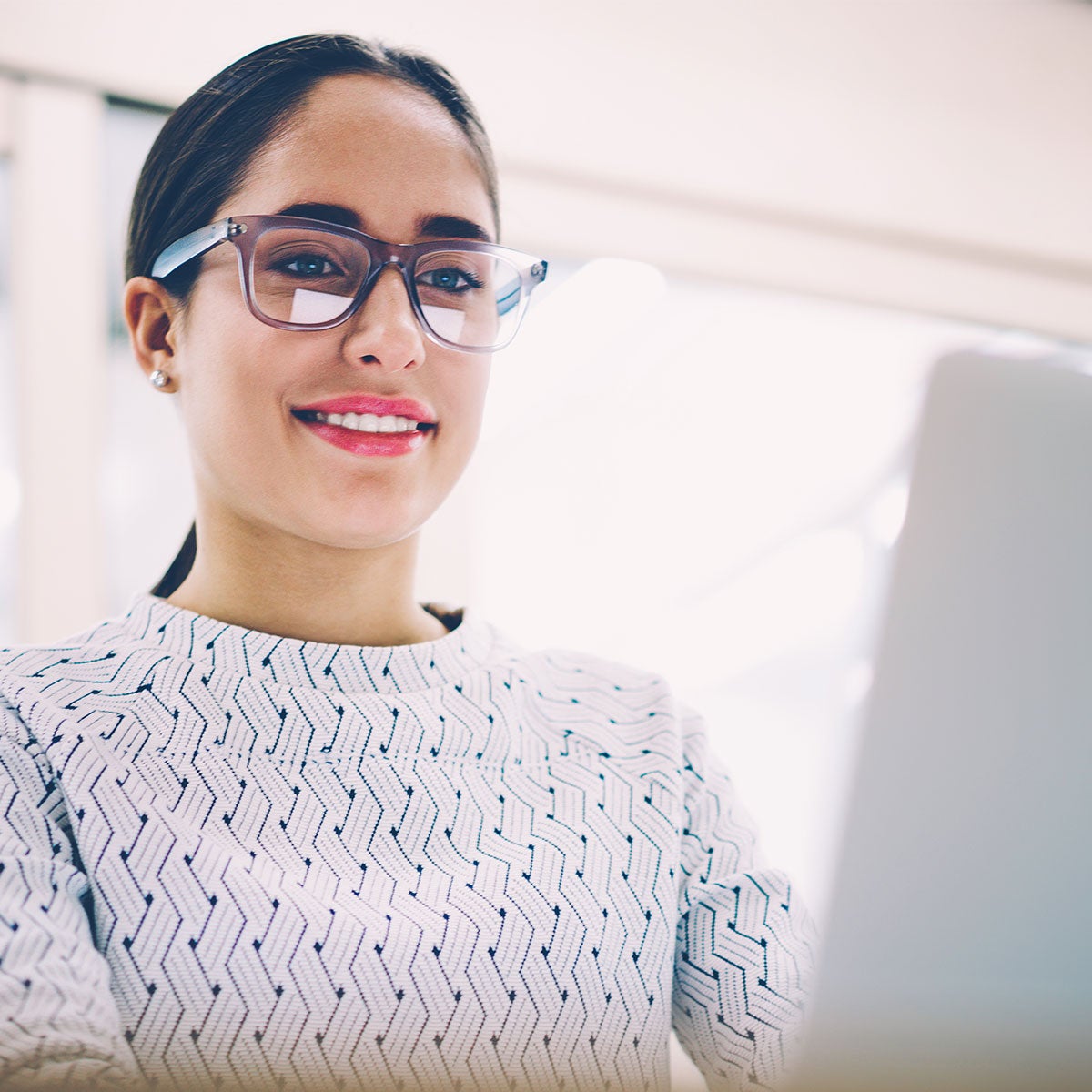 A person with a glasses fills an application online