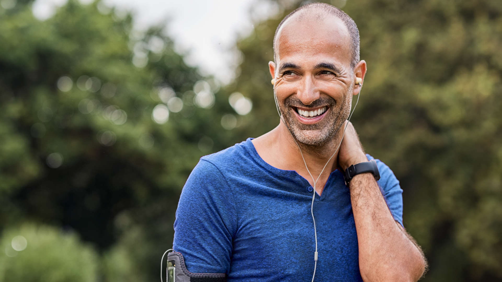A man smiling with earphones
