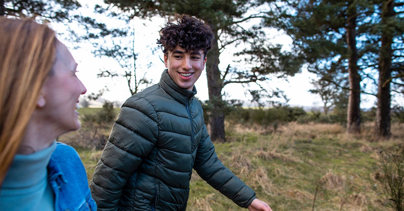 Young person walking in the woods for a leisure walk
