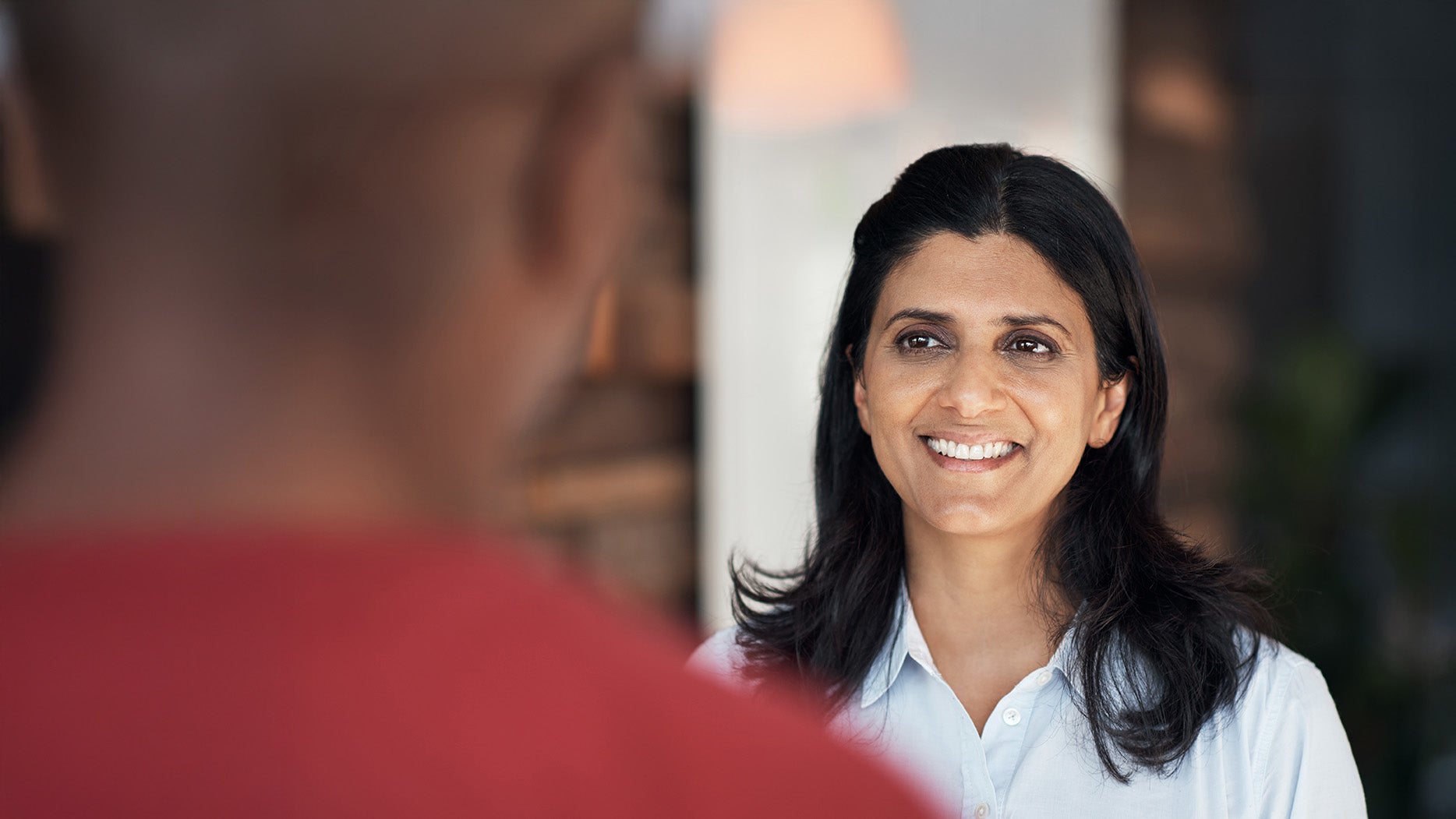 A woman smiling at another man