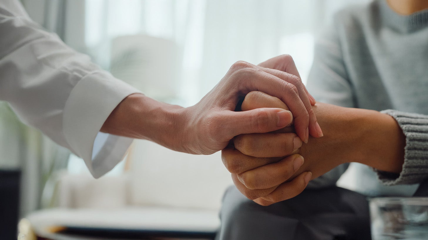 A close-up of a person holding hands