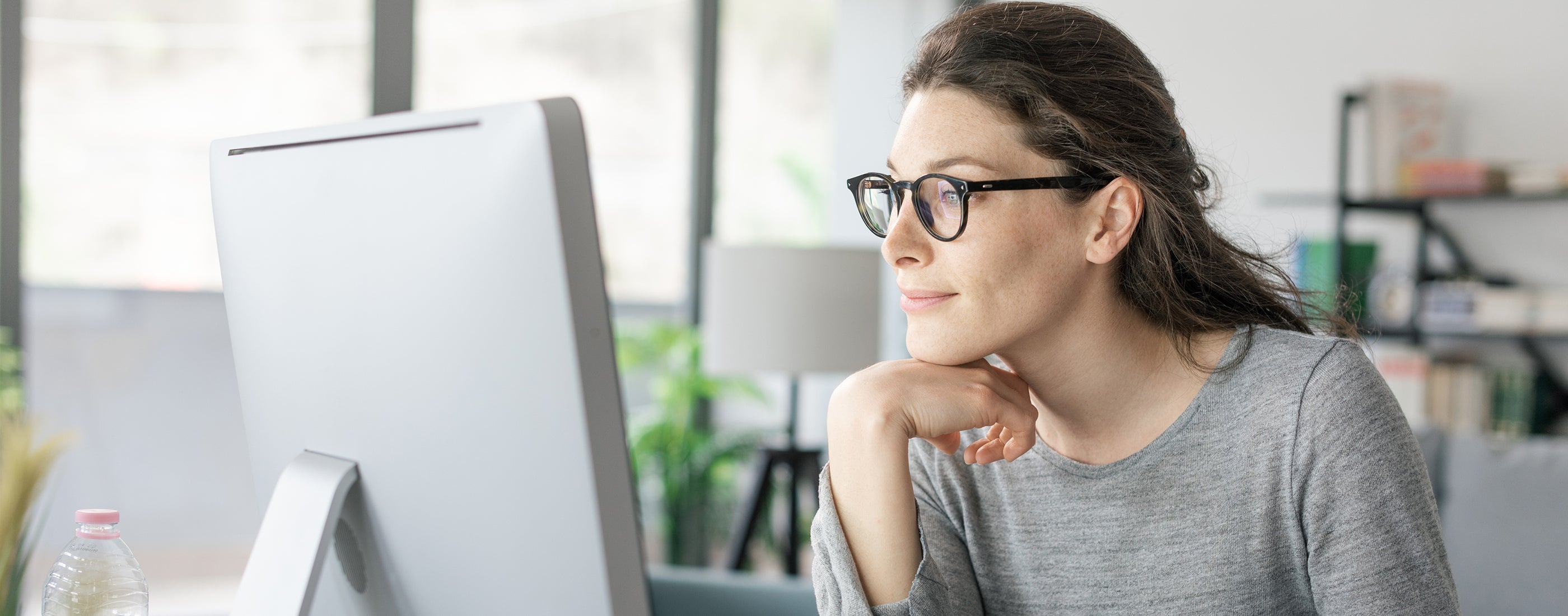 A woman looking at the computer screen