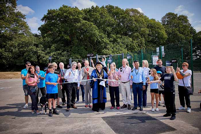 The Sheriff of Southampton cuts a ribbon to the new play park facilities with guests in the background.