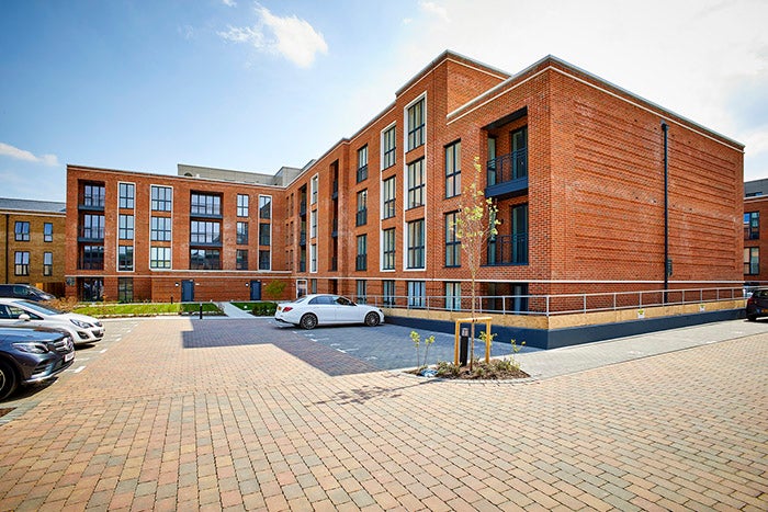A wide angle shot of Knights quarter in Winchester. The building is red brick and industrial looking