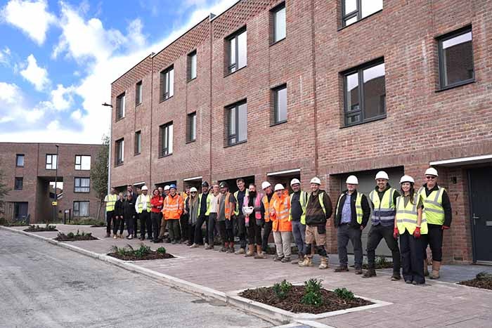 Guests from SNG and YTL Developments gather outside the affordable properties.