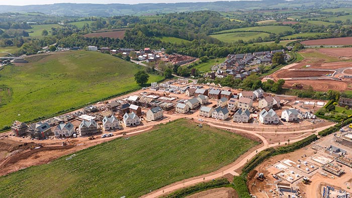 Aerial view of a newly built housing development in Exeter, surrounded by fields
