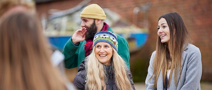 A mixed group of people standing outside