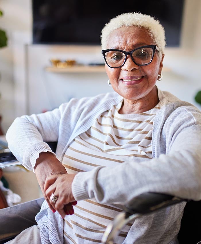 An elderly woman sat in a chair