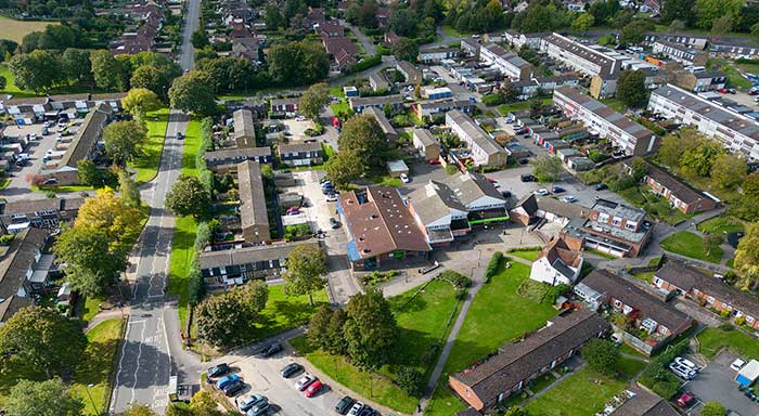 Aerial view of a residential neighbourhood with green spaces and housing.