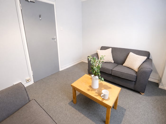 Shared living area with sofas, coffee table and window