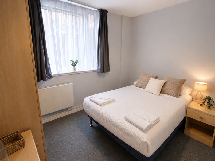 Double bedroom with bed, wardrobe and bedside furniture
