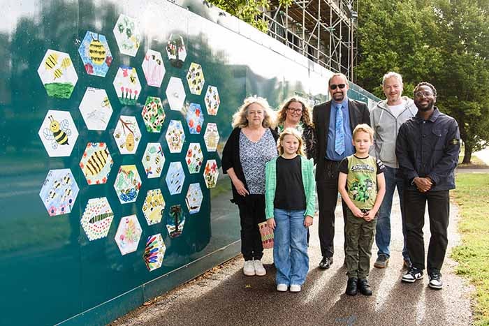Children, church leaders and SNG staff stand in front of artwork