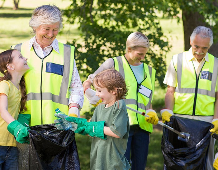 A group of people wearing hi-vis jackets litter picking in their local community