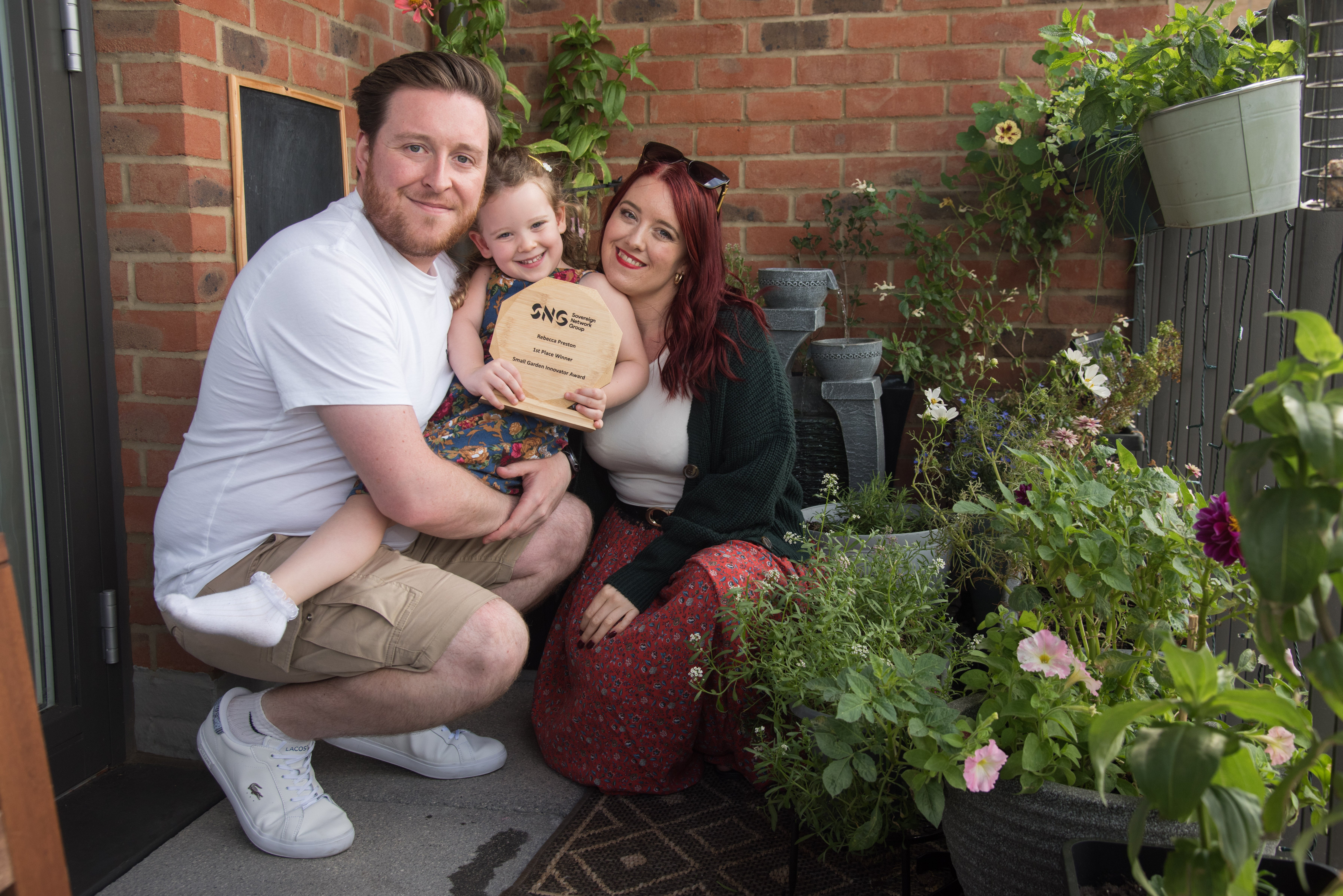 Small garden innovator winner and her family with the trophy