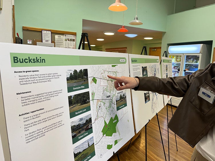 Resident reviewing community consultation display boards