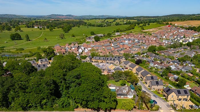 Aerial view of a residential housing development surrounded by open countryside.