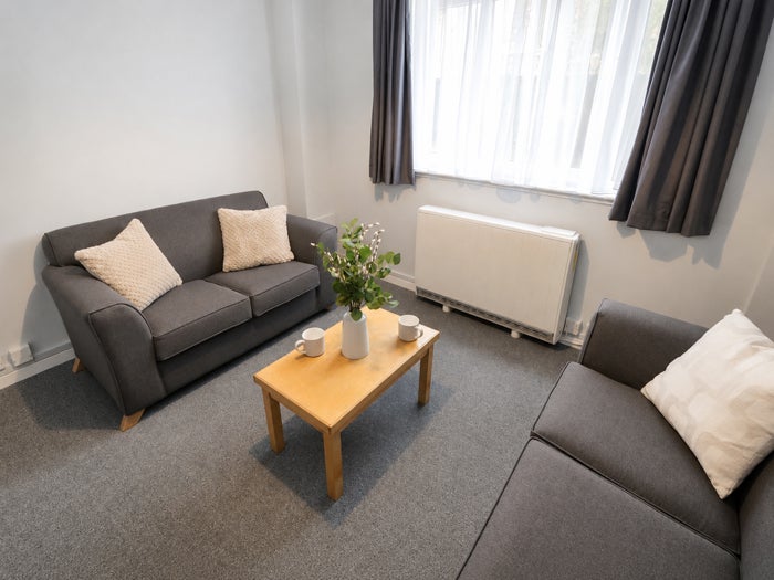 Bright communal lounge with sofa seating and coffee table