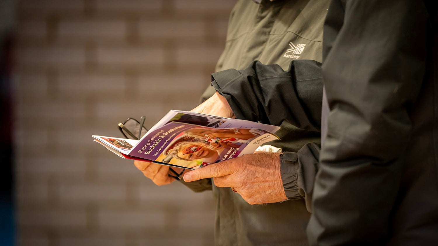 A person holding a booklet