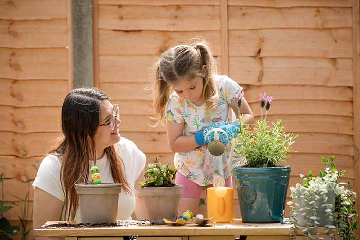 An SNG customer with her daughter in their garden