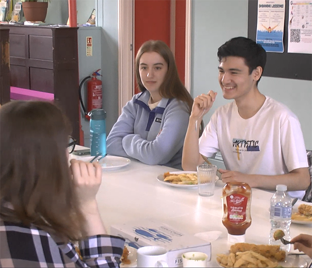 Some young people sat around a table