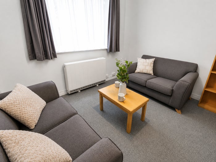 Communal living room with two sofas and a coffee table