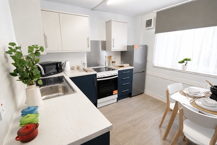 Modern fitted kitchen with dining area and integrated appliances