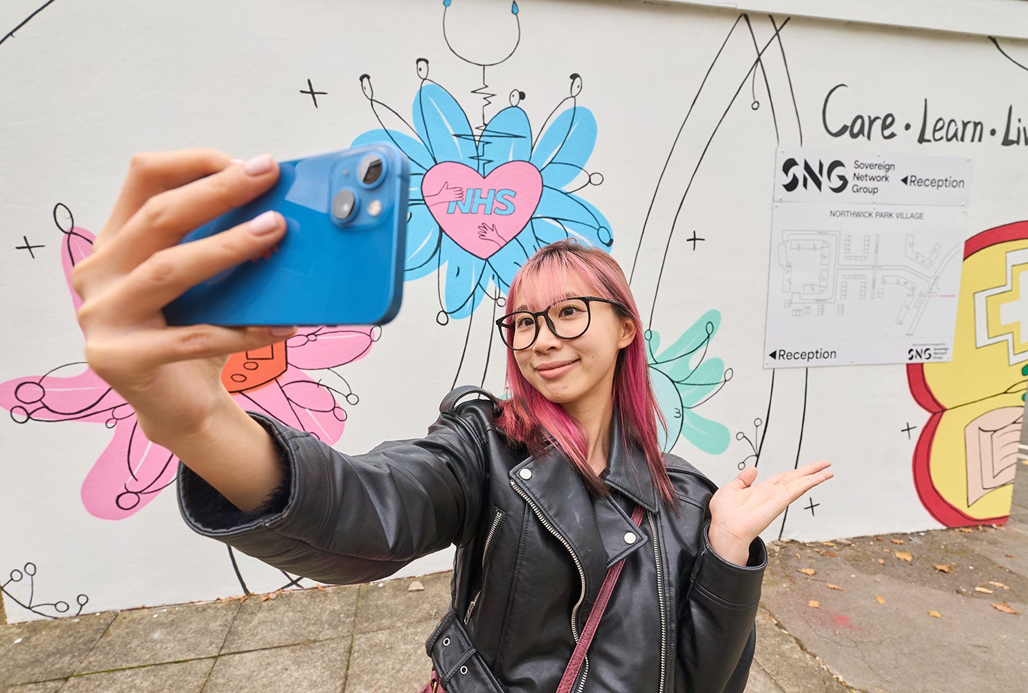 Student Lexi in front of her artwork at Northwick Park.