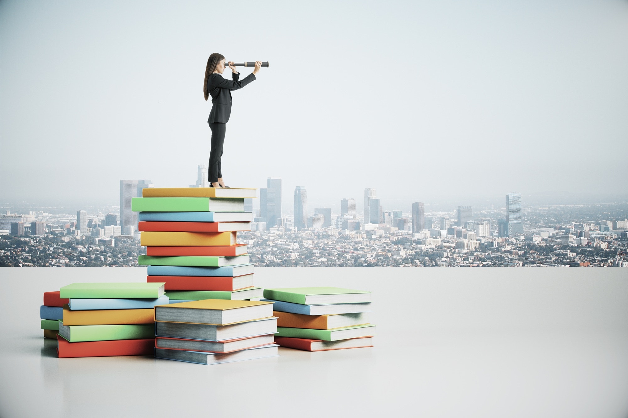 A woman standing on top of a pile of colourful books with a city in the background, looking through a telescope