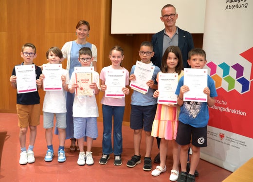 Prämierungsfeier Känguru der Mathematik 2026: 2. Klasse Grundschule – Kategorie Felix (von links): Elia Vieider, Nathan Moser, Felix Haller, Sara Gurschler, Leo Ibolekwu, Lina Maria Bertagnolli, Florian Fischnaller, dahinter Landesschuldirektorin Sigrun Falkensteiner und Abteilungsdirektor Martin Holzner (Foto: LPA/Deutsche Bildungsdirektion/Margit Pichler)