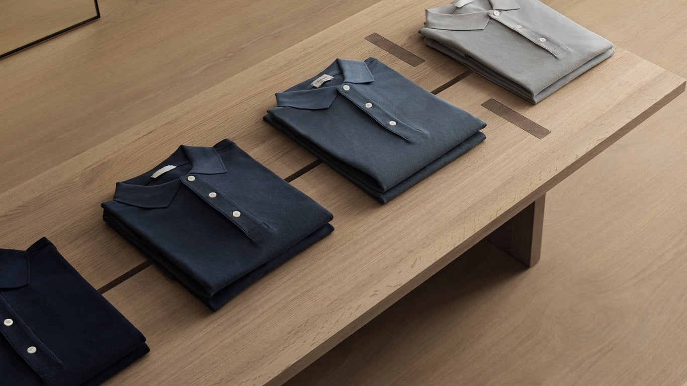 A group of folded shirts on a table - wood veneer - decospan - Shinnoki natural oak