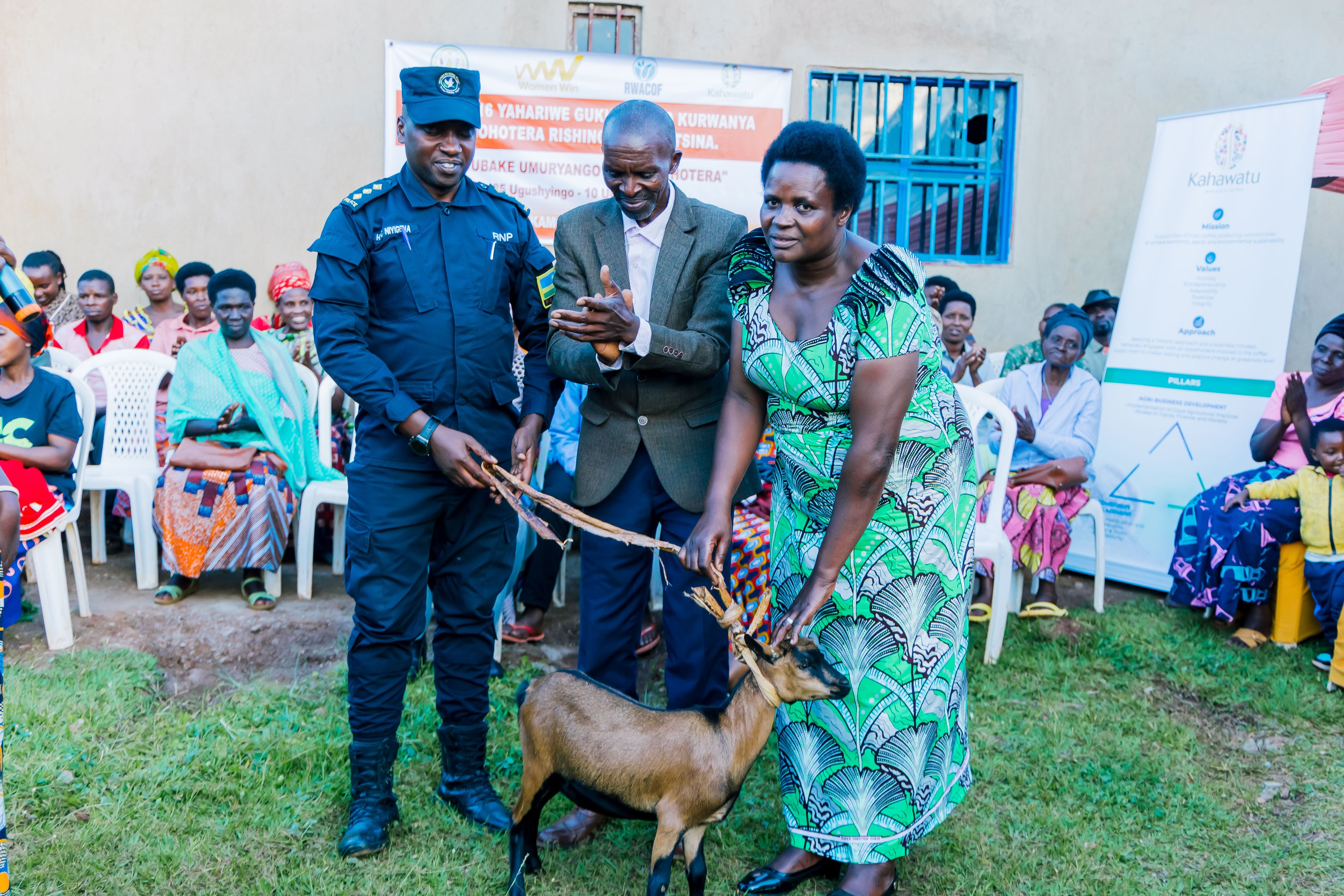 VSLA members in Rwanda with livestock (goat) distribution