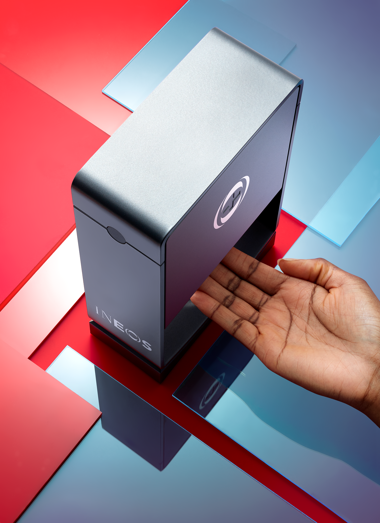 a top down photo of someone using an ineos hygienics hand sanitiser dispenser